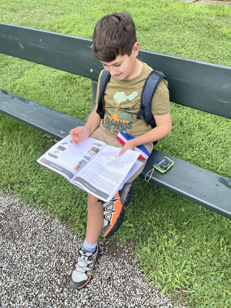 Child sitting on a bench working on a workbook