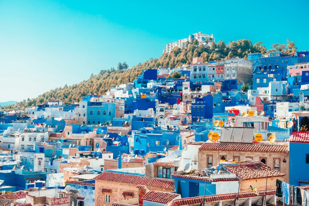 Houses along the hillside in various shades of bright blue in Chefchaouen, Morocco, in the valley of the Rif mountains