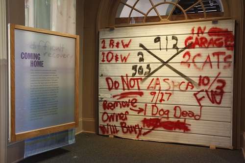 Garage door tagged from Hurricane Katrina damage on display in The Prebytere Museum in New Orleans