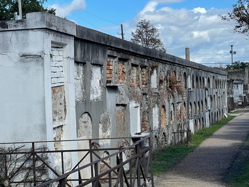 Above ground tombs in a wall inside St Louis Cemetery No. 1 in New Orleans