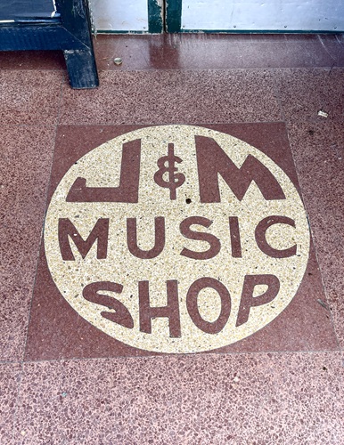 Label saying "J&M Music Shop" on the floor near the entryway of the former J&M Records studio in New Orleans